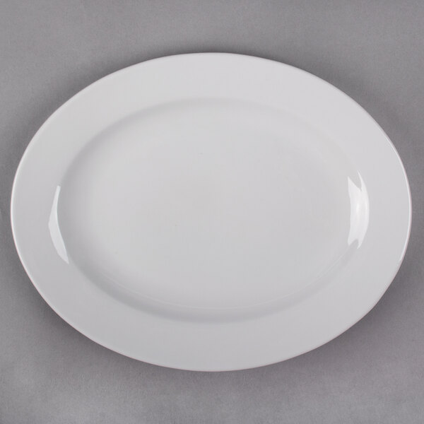 A white Libbey porcelain platter with a white rim on a gray surface.