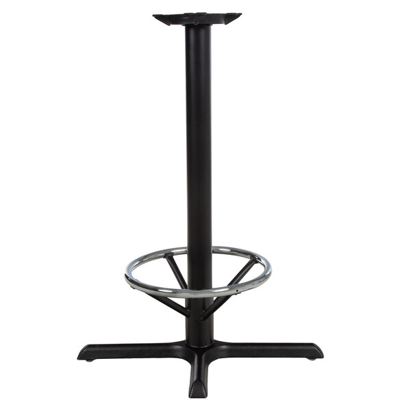 A black Lancaster Table & Seating cast iron bar height table base with a foot ring.