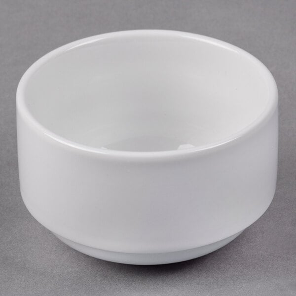 A Libbey white porcelain bouillon cup on a gray surface.