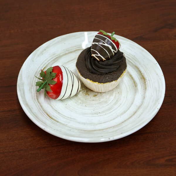 A chocolate cupcake with a chocolate strawberry on top on an Elite Global Solutions Van Gogh taupe melamine plate.