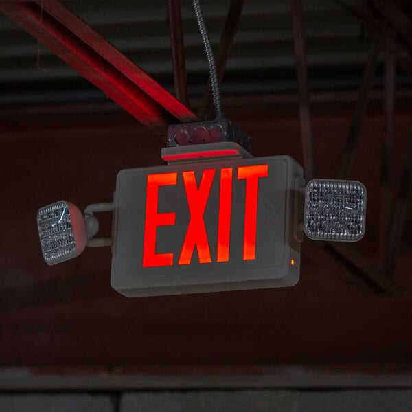 A red Lavex exit sign with lit up letters hanging from a ceiling.