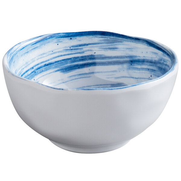 A white melamine bowl with blue paint on it.
