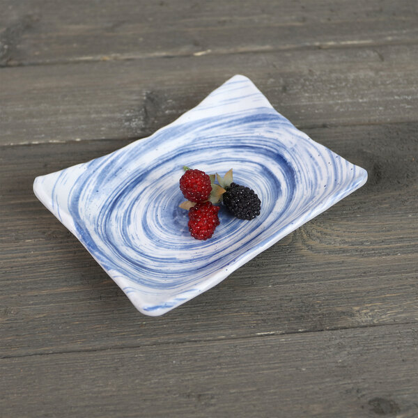 An Elite Global Solutions navy rectangular melamine plate with berries on it.