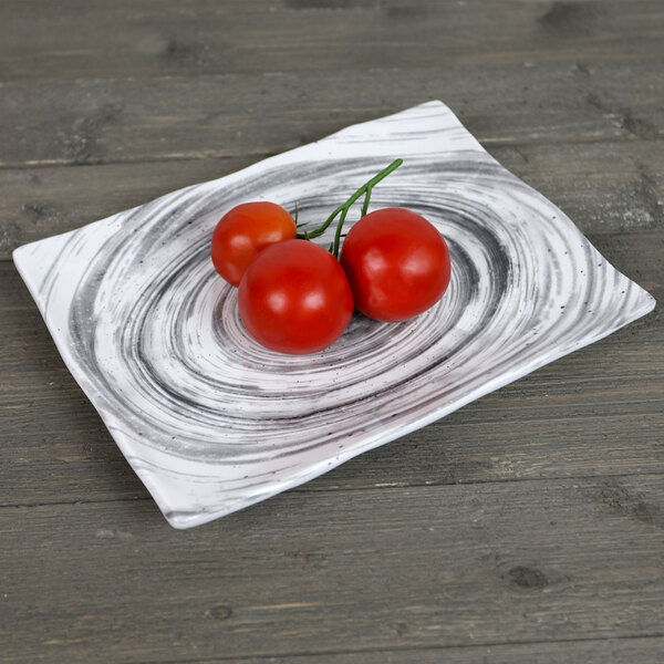 A Elite Global Solutions Van Gogh black rectangular melamine plate with tomatoes on it.