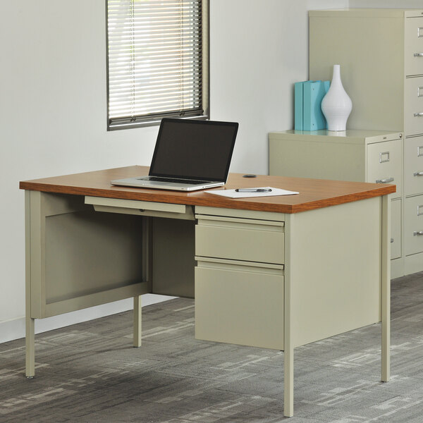 A Hirsh Industries single pedestal desk with a laptop on it.