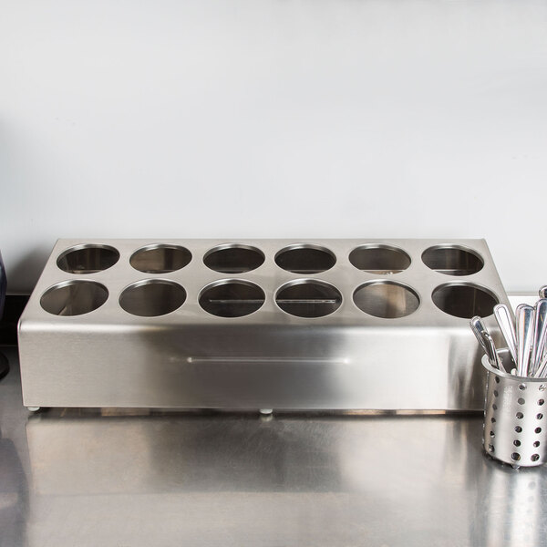 A Steril-Sil stainless steel countertop flatware organizer with utensils in it.
