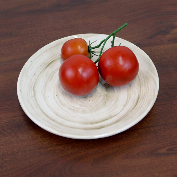 An Elite Global Solutions Van Gogh taupe melamine plate with tomatoes on it on a table.