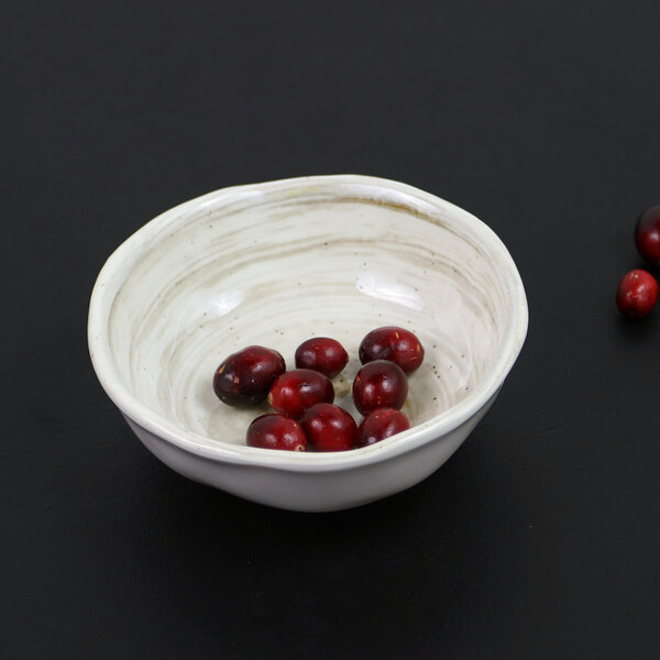 A Elite Global Solutions taupe melamine bowl filled with red berries.