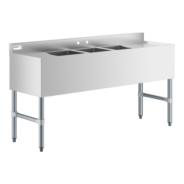 A stainless steel three-compartment sink with two drainboards and four sturdy legs.