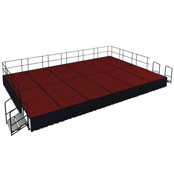 A red stage with black skirting set up outdoors.