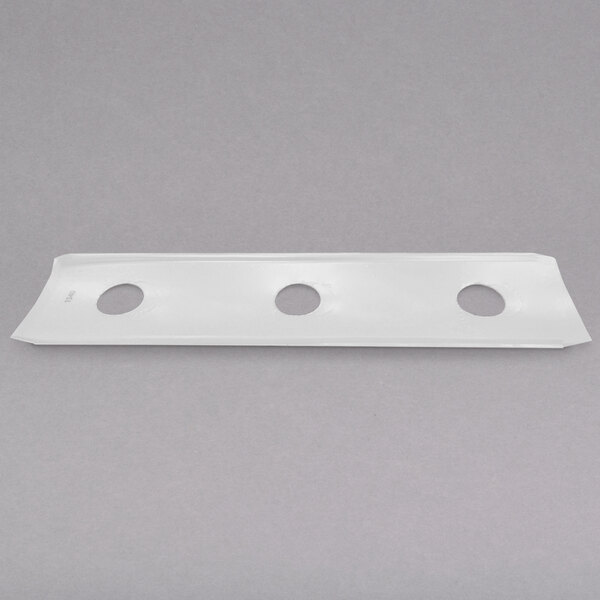 A white rectangular plastic object with holes in it.