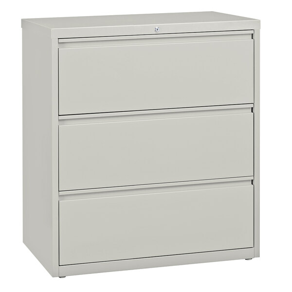 A gray Hirsh Industries three drawer lateral file cabinet.