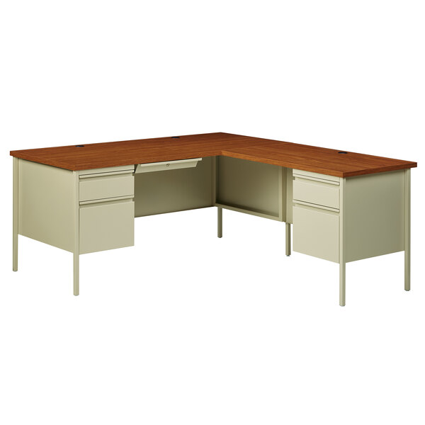 A Hirsh Industries oak corner pedestal desk with a wooden top and two drawers.