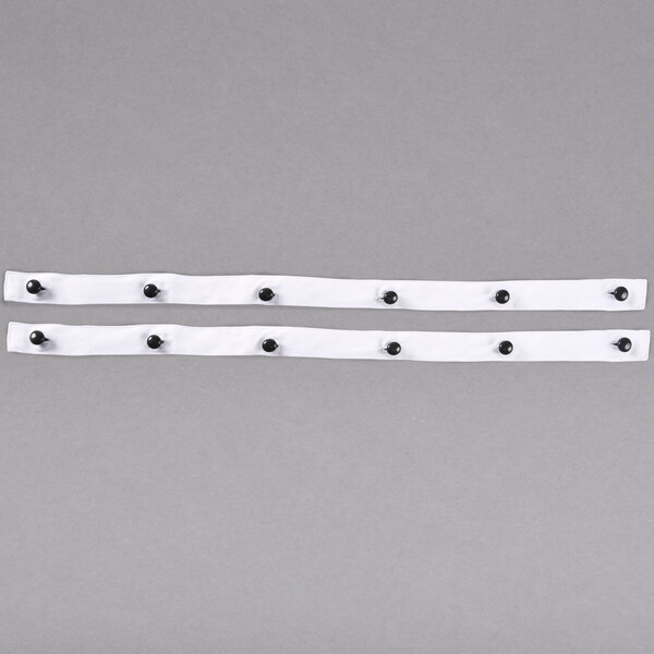 Two black button strips with white dots on them.