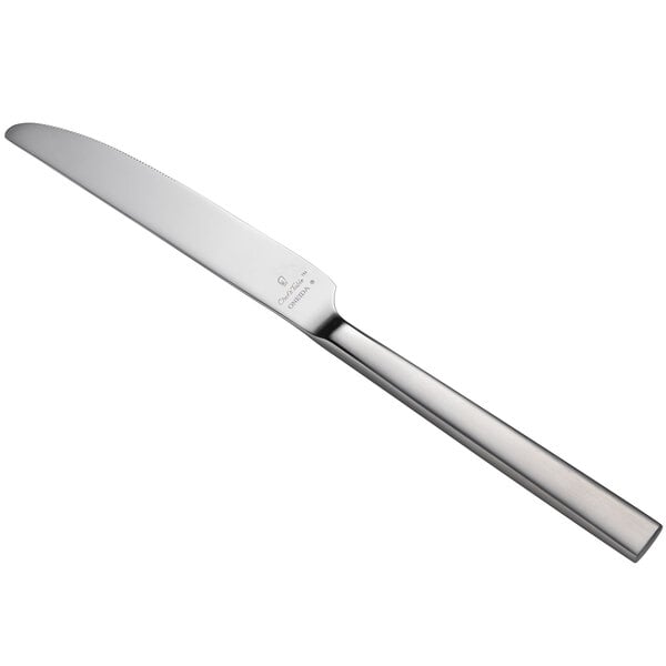 A close-up of a Oneida Chef's Table Satin stainless steel dinner knife with a silver handle.