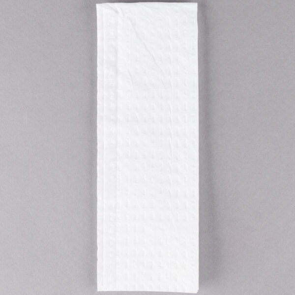 A white tissue paper on a gray background.