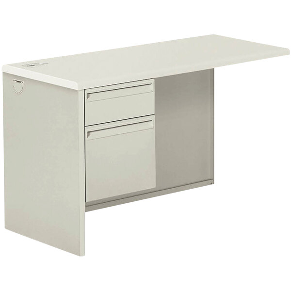 A white desk with a left pedestal and drawers.