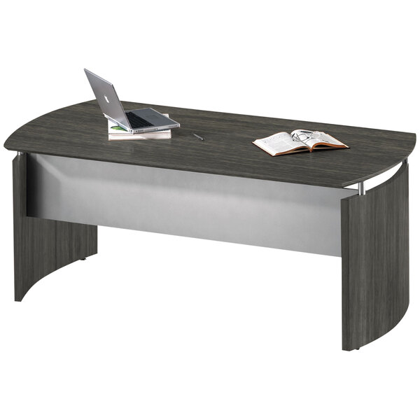 A Safco Medina gray steel laminate curved desk base with a laptop and a book on it.