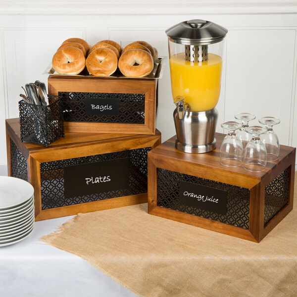 A Tablecraft Farmhouse acacia wood riser set on a hotel buffet table with breakfast items displayed on them.