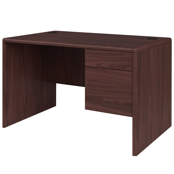 A mahogany laminate HON pedestal desk with a right drawer.