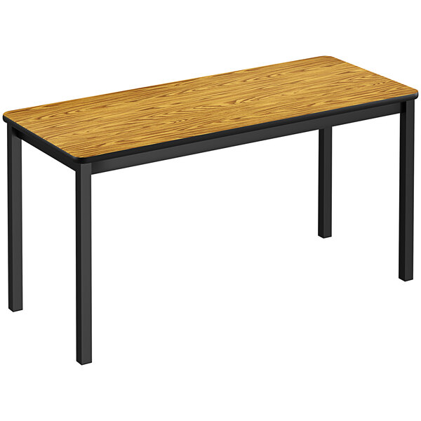 A medium oak rectangular Correll lab table with black legs.
