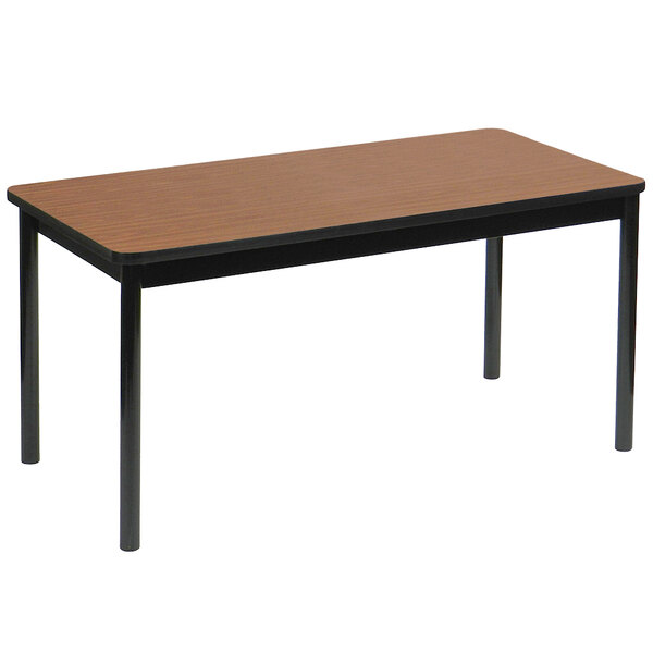 A rectangular Correll lab table with black legs and a medium oak top.