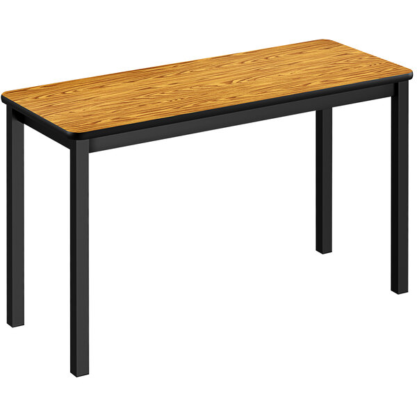 A medium oak Correll lab table with black legs.