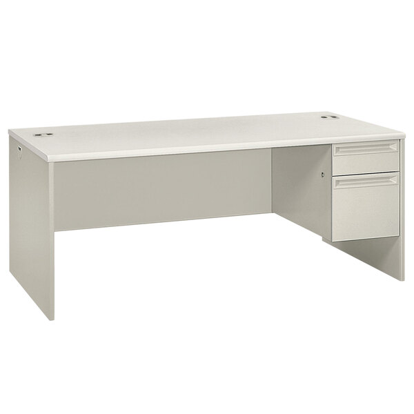 A silver mesh and light gray laminate HON 3/4 height single pedestal desk with a drawer.