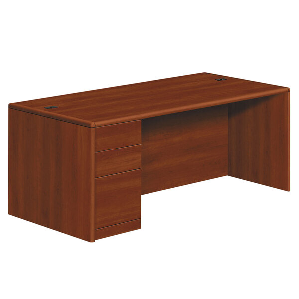 A brown wooden HON 10700 Series desk with drawers.