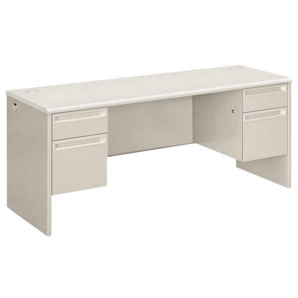A silver and gray HON pedestal credenza desk with drawers.