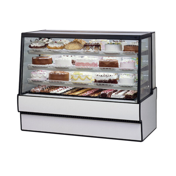 A Federal Industries refrigerated bakery display case filled with cakes.