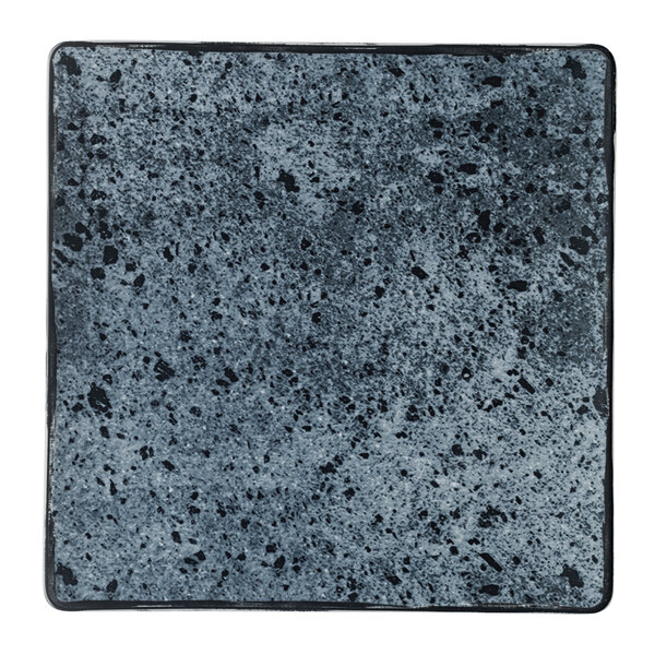 A white square porcelain coupe plate with black and grey stone-like speckles.