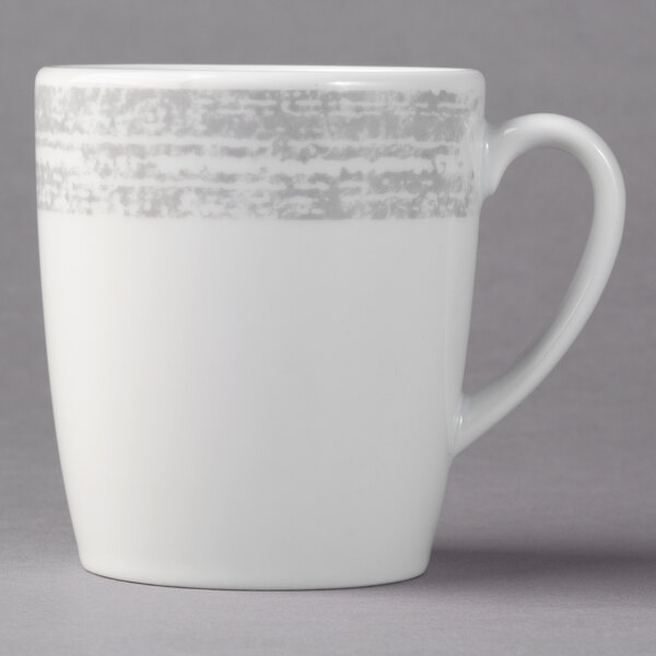 A white porcelain tall coffee mug with a grey rim and handle.