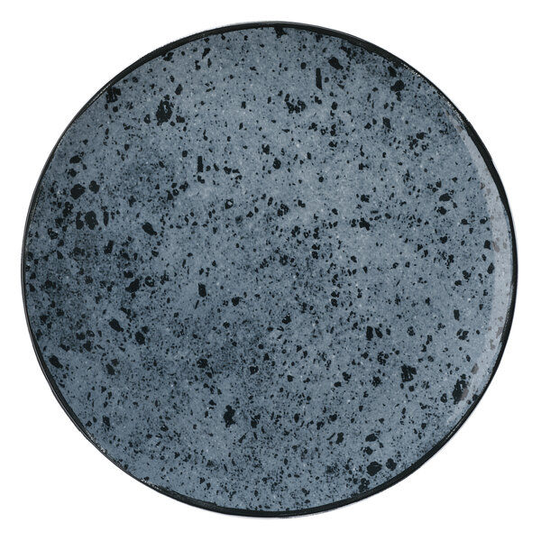 A Schonwald Shabby Chic stone porcelain coupe plate with black and gray speckles on it.