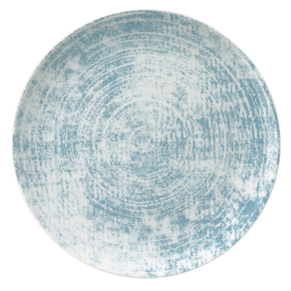 A close-up of a Schonwald Structure Blue round porcelain coupe plate with a blue and white surface.
