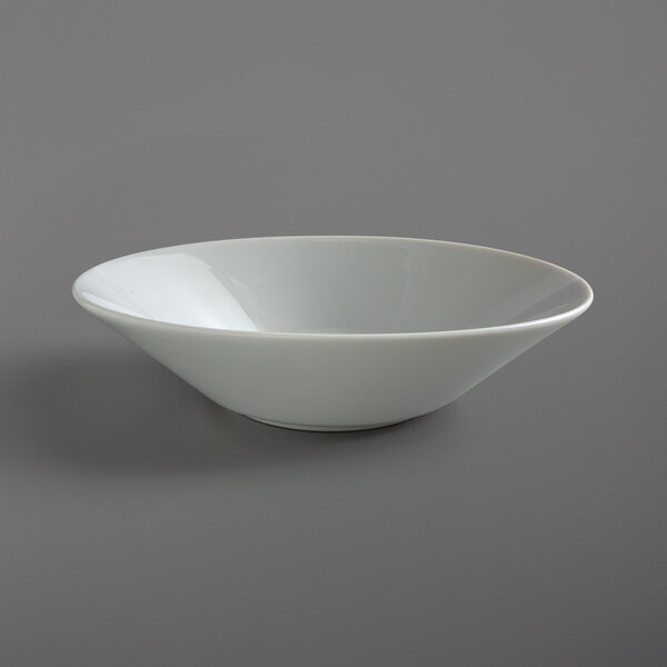 A Schonwald white porcelain deep bowl on a gray surface.
