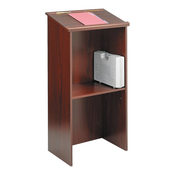 A Safco mahogany stand-up lectern with a white case on top.