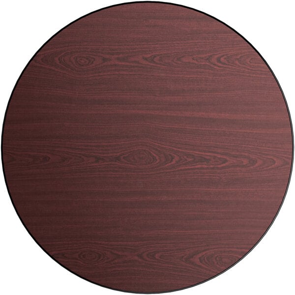 A Lancaster Table & Seating round table top with a reversible cherry and black surface.