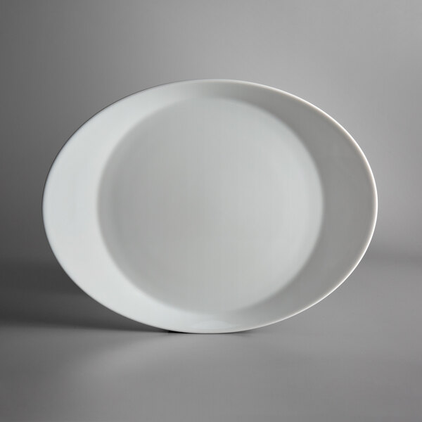 A white Schonwald oval porcelain dinner plate with a rim.