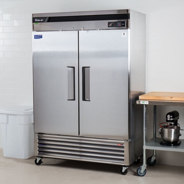 A large silver Turbo Air reach-in refrigerator with two solid doors.