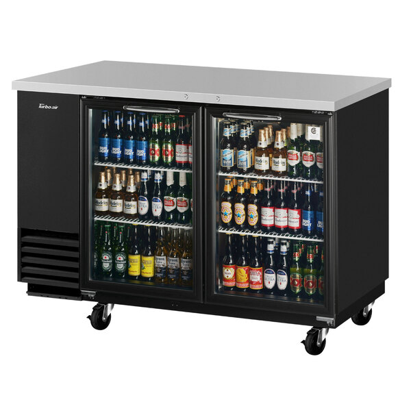 A black Turbo Air back bar refrigerator with glass doors holding bottles of beer.