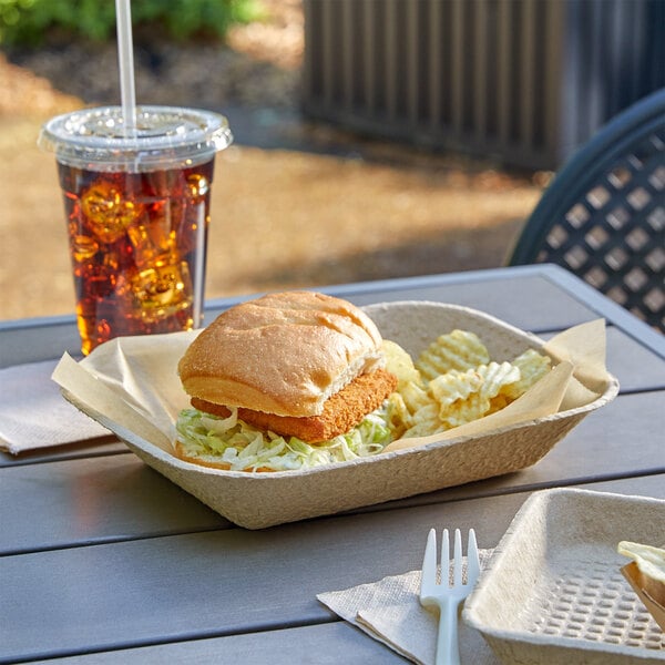 A sandwich and a drink on an EcoChoice rectangular tray on a table.