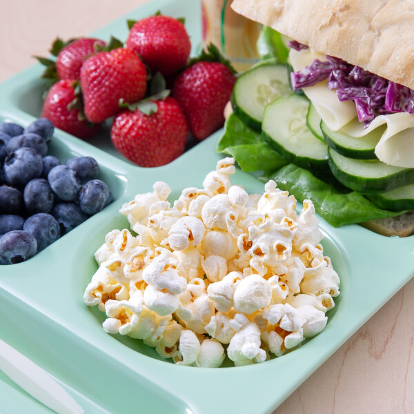 A sandwich and popcorn on a tray.