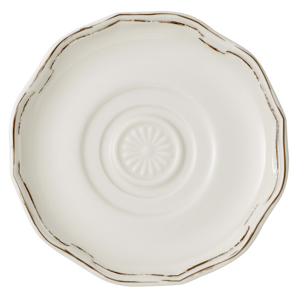 A white Villeroy & Boch saucer with a circular brown design.