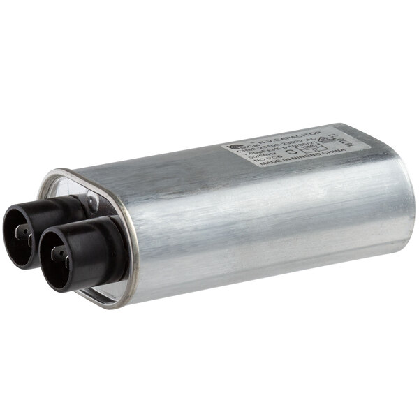 A Solwave capacitor with black connectors on a silver metal cylinder.