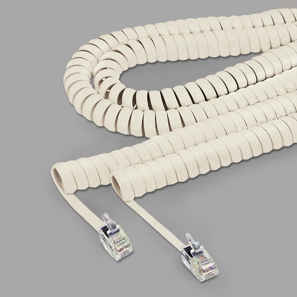 A close-up of a white Softalk telephone cord with plugs.