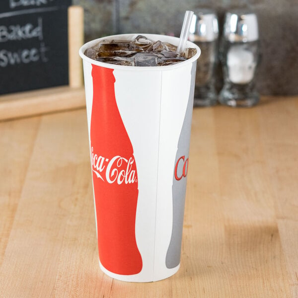A white Solo paper cold cup with a brown Coke logo and a straw in it.
