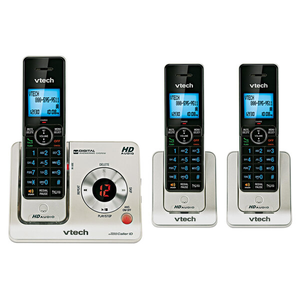 A Vtech black and silver cordless phone with buttons and 2 additional handsets.