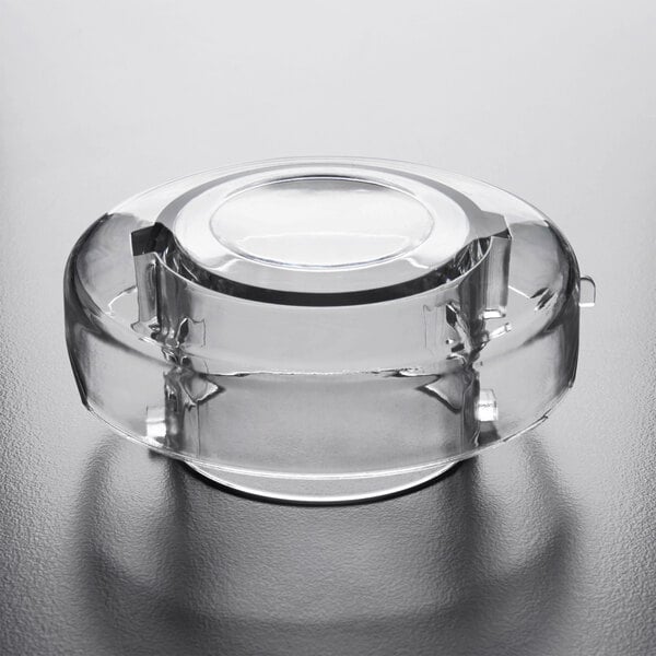 A clear glass container with a round top.