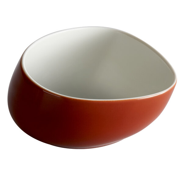 A Schonwald porcelain bowl with a white rim and a red bottom.